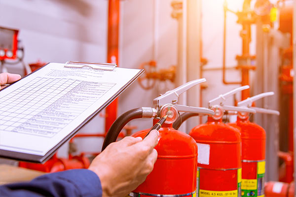 Inspecting fire extinguishers with a checklist