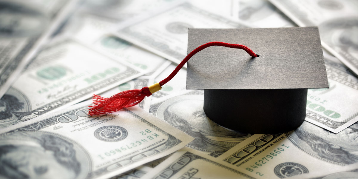 graduation cap on top of $100 bills